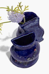 Blue ceramic vase bookends with speckled polka-dot style detailing