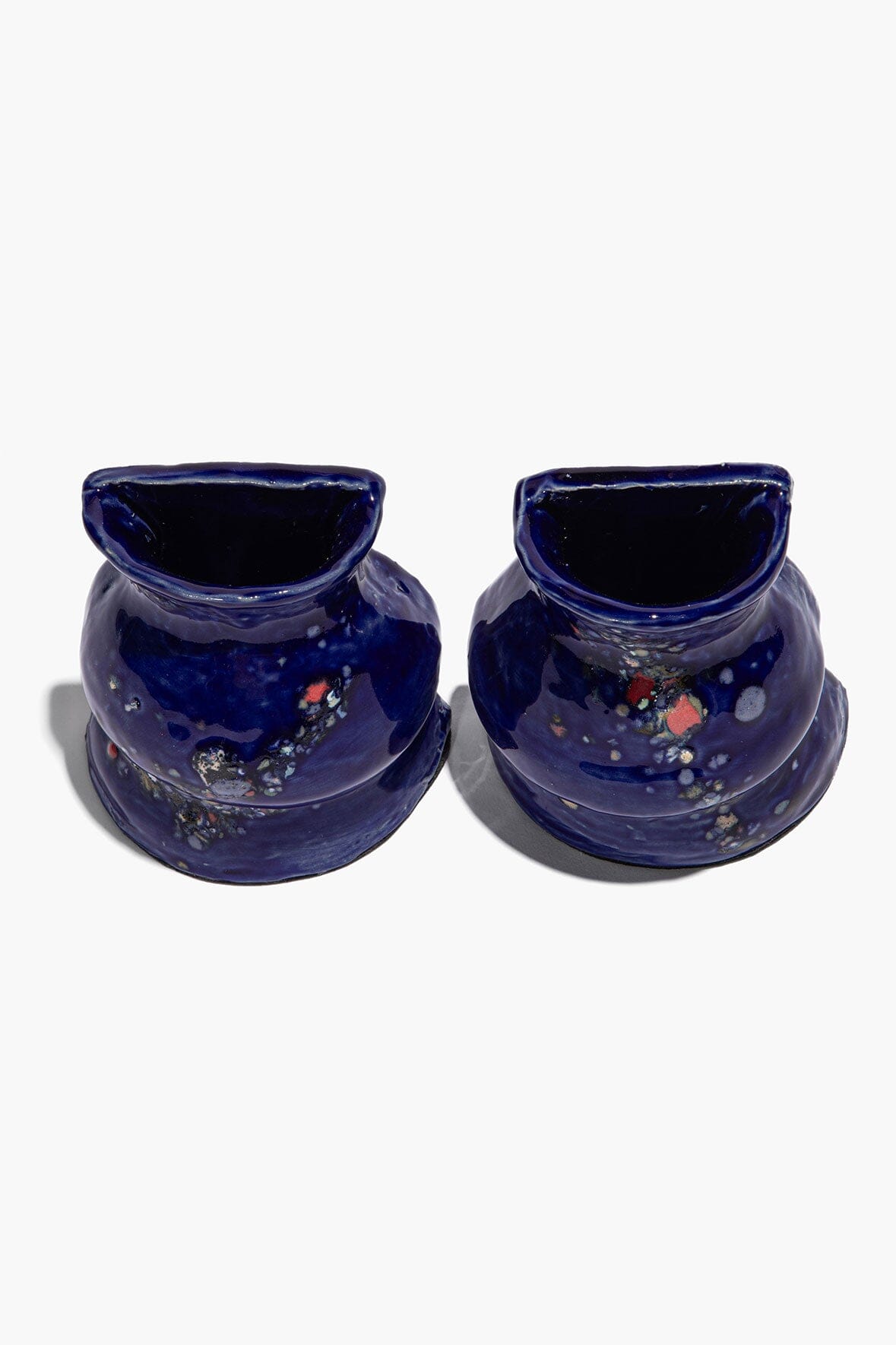 Pair of dark blue ceramic vase bookends, speckled polka-dot finish