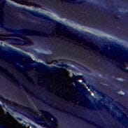Textured indigo-glaze mirror surface close-up with glossy streaks