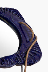 Indigo-glaze round hanging wall mirror, close side view of textured blue frame