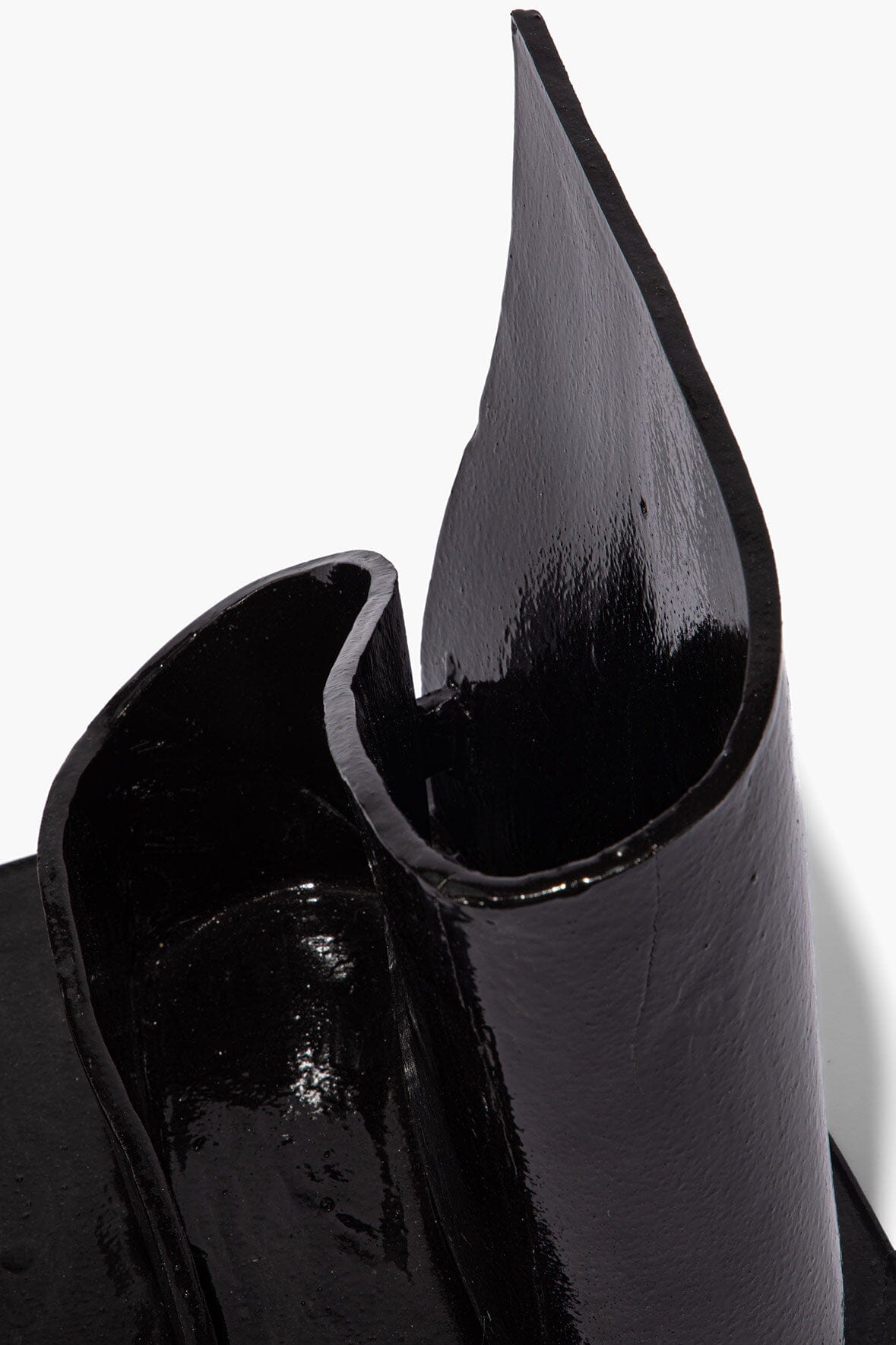 Black glazed wavy holder close-up, curved teardrop opening with glossy finish