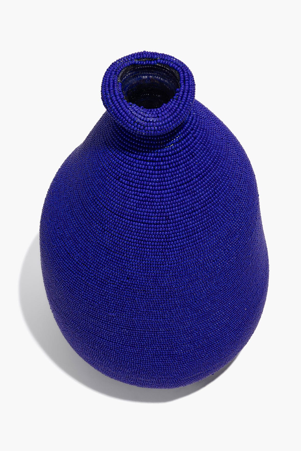Blue hand-beaded vase with woven bead texture and rounded body