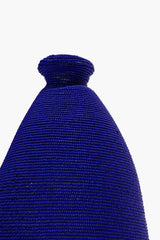 Blue hand-beaded vase neck with tight woven bead pattern
