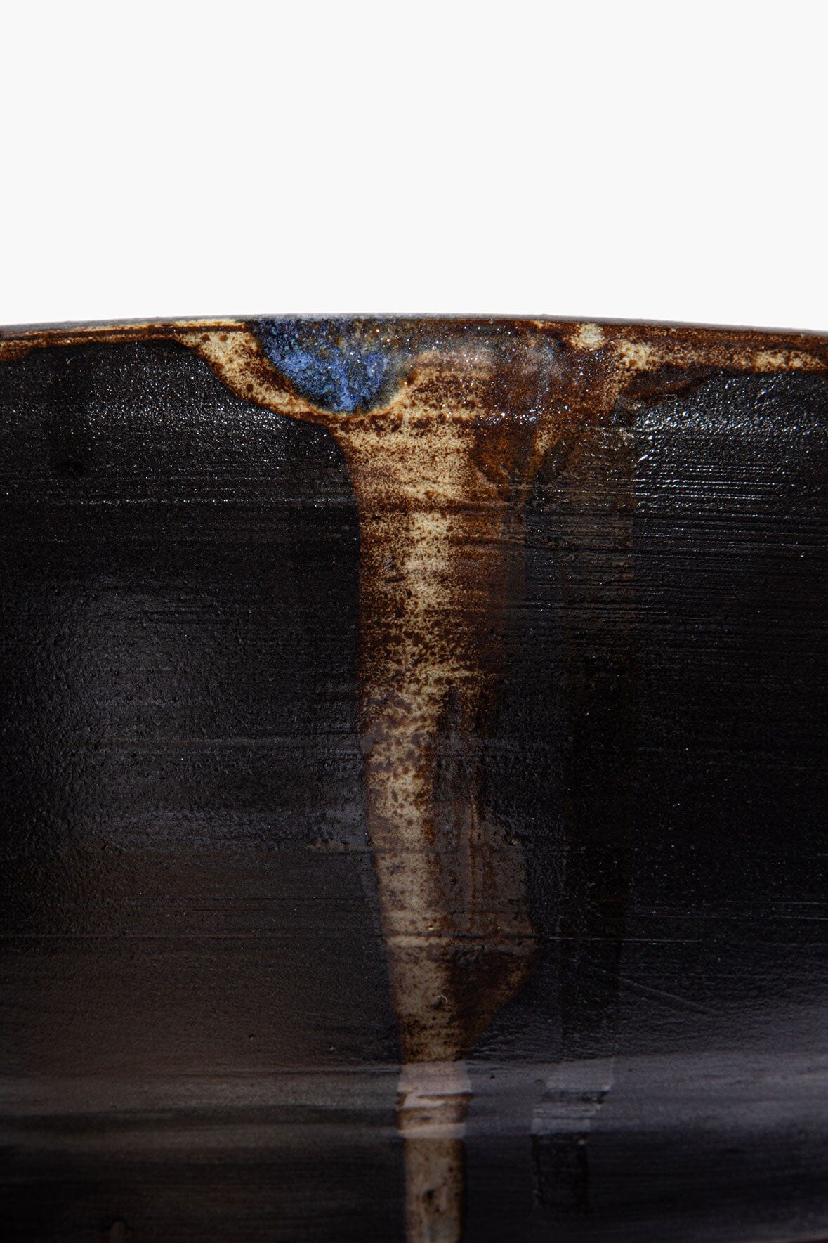 Large ceramic candle, dark ceramic with blue and brown glaze drip detail