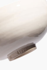 Large ceramic candle in white ceramic vessel with embossed SERRE on rim