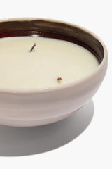 Large ceramic candle close-up of cream wax in white ceramic bowl with wick