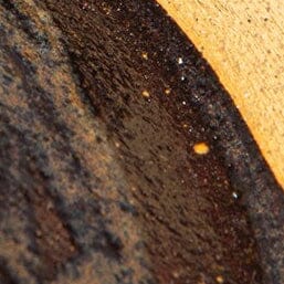 Ceramic leather-look coaster surface texture, dark speckle with specks