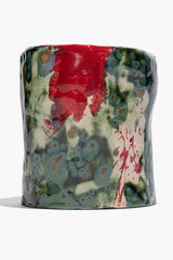 Medium ceramic candle in red-and-green speckled glaze, cylindrical holder