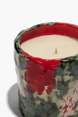 Ceramic candle top with red glazed rim, off-white wax, and centered wick