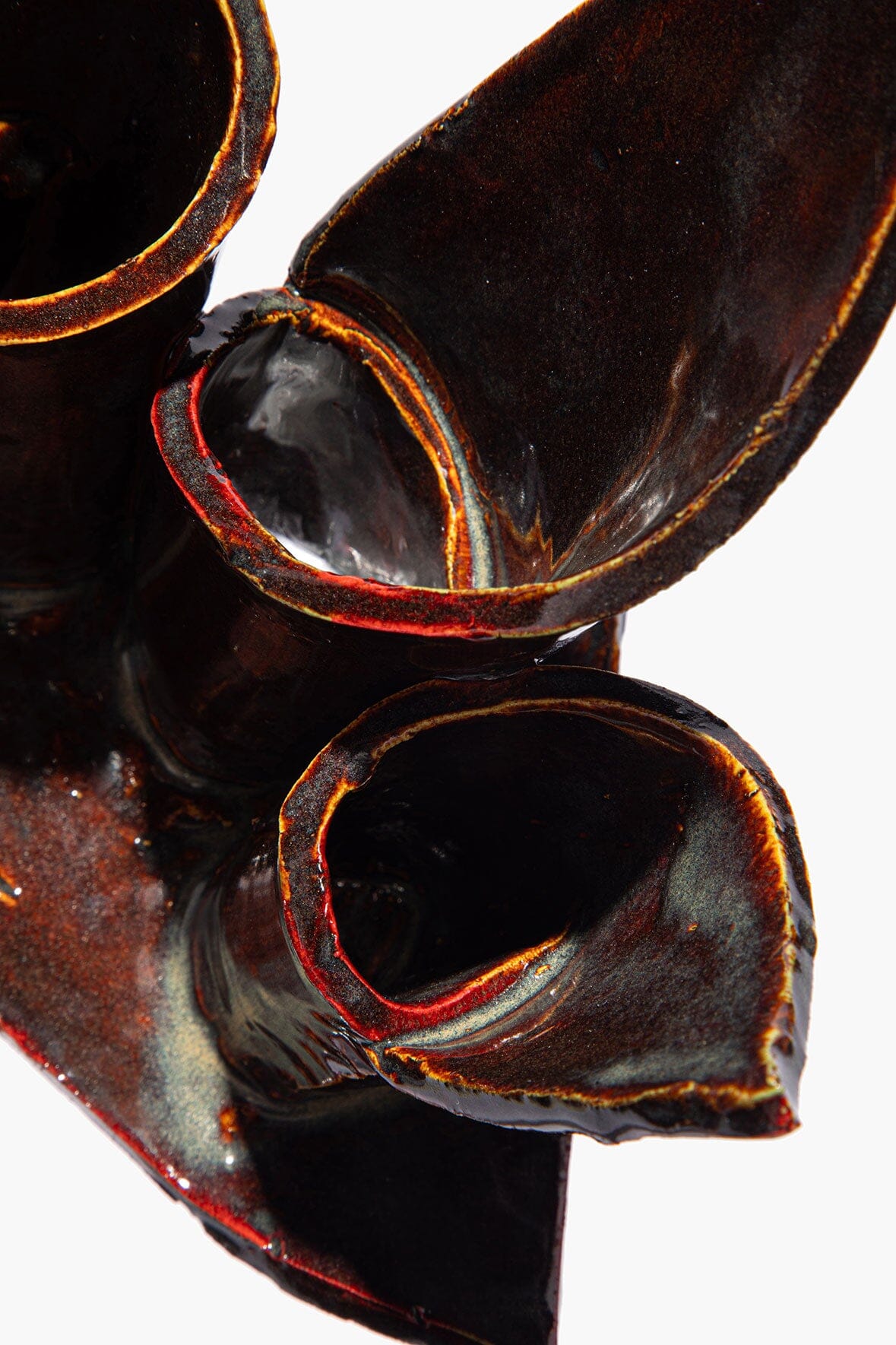 Ceramic triple candleholder close-up of maroon wash glaze candle cups and glossy rim
