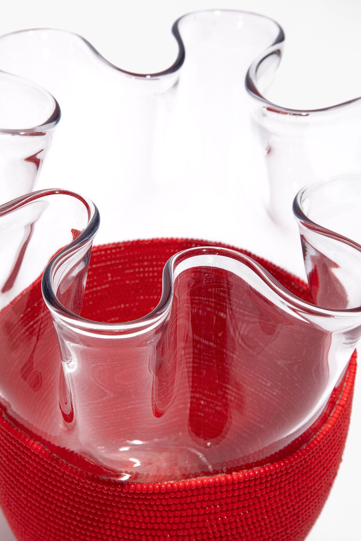 Red beaded vase with wavy clear glass rim