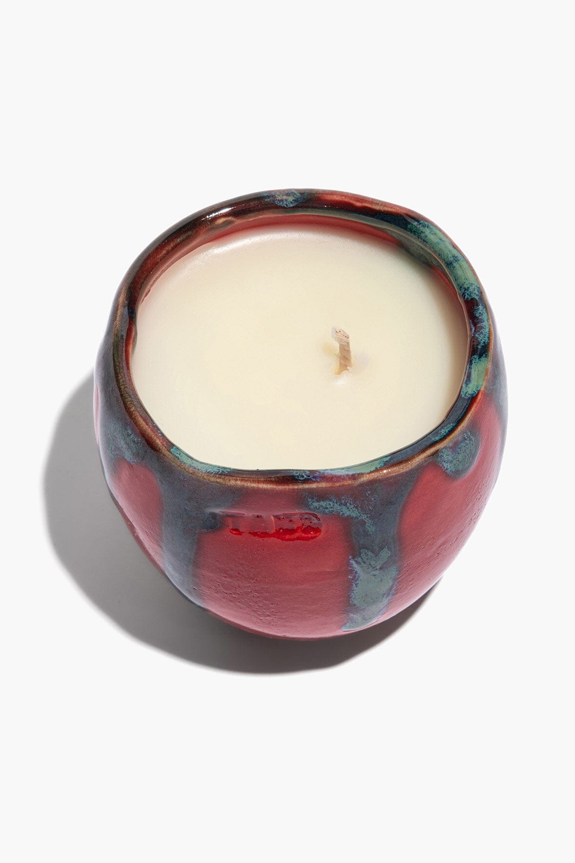 Small SERRE ceramic candle top view, cream wax center with teal-blue rim