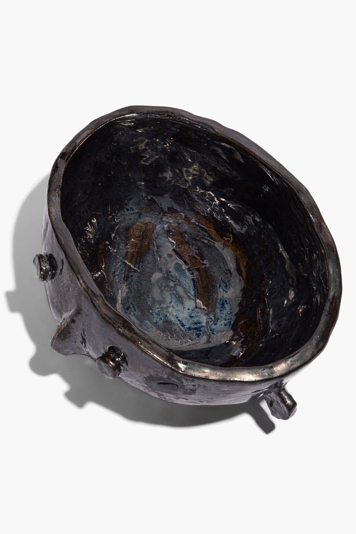 Large Henry bowl in dark glaze, sculpted rim and side knobs; inner blue sheen visible.