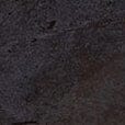 Close-up of dark glazed ceramic surface with mottled texture and sheen.