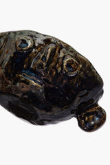 Small Henry bowl angled view, dark glazed ceramic with face-like round details