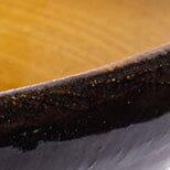 Stacked cone vase glaze close-up showing dark rim and mustard inner edge