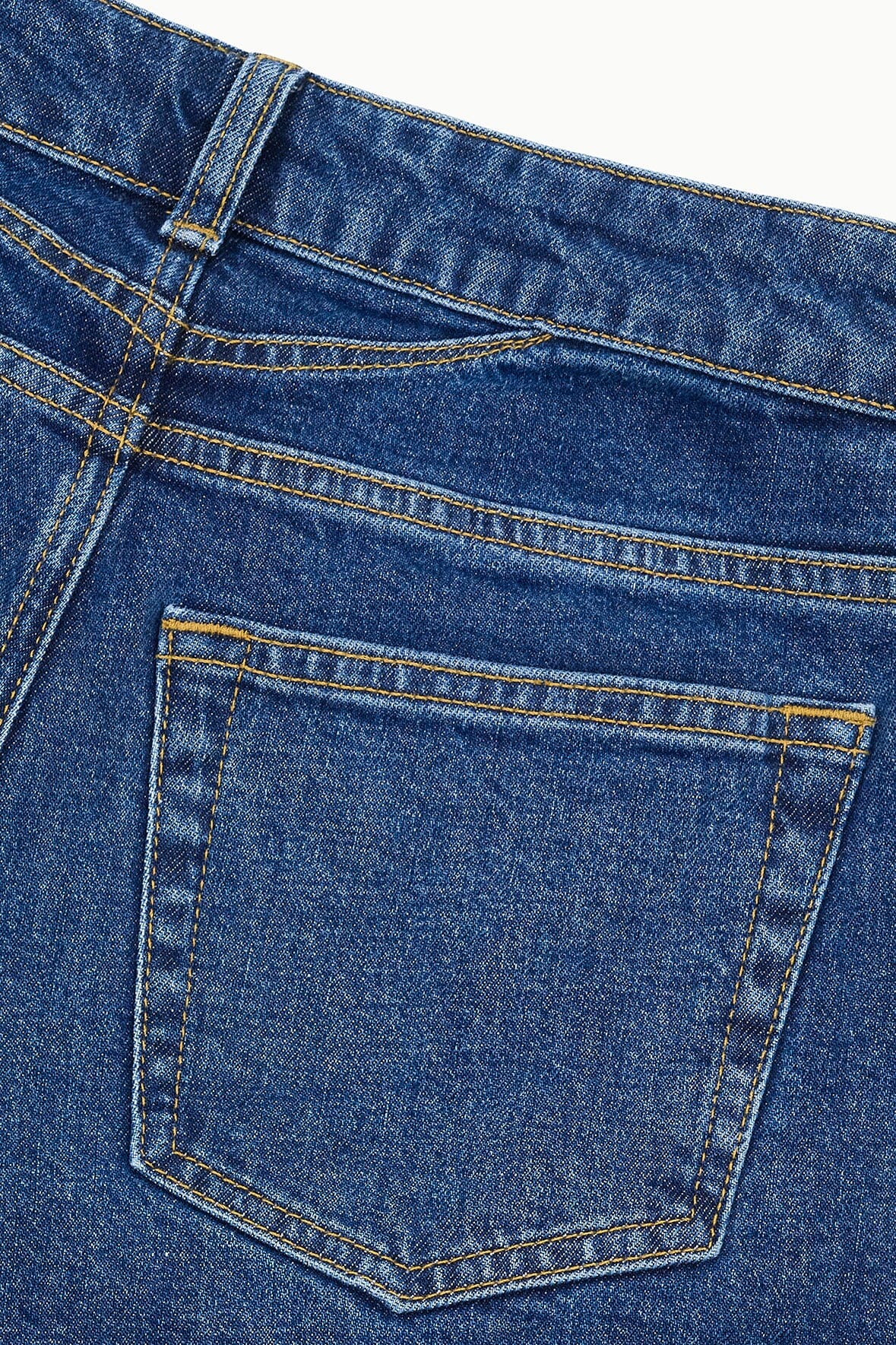 Stone blue denim back pocket with contrast topstitching and stitched outline