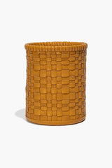 Woven goldenrod leather candle holder, round with open top and visible wick candle