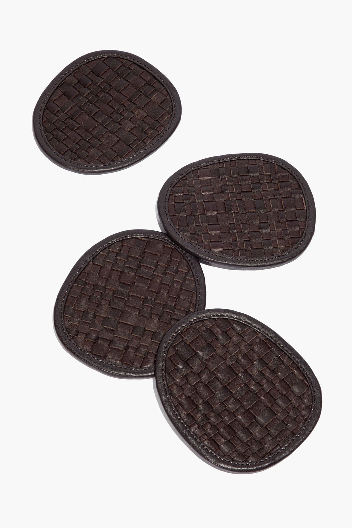 Four round woven leather coasters, dark espresso brown, braided basket weave texture
