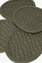 Moss woven leather coaster close-up with round stitched border and checker weave