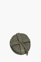 Moss woven leather coaster set held by a leather wrap strap