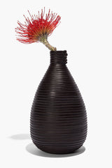 Wrapped vase in dark espresso brown with ribbed texture and red stems