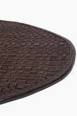 Espresso leather placemat edge with stitched border and woven basketweave texture