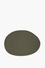Oval moss green leather placemat with woven grid texture