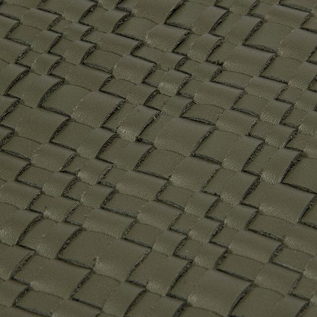 Olive-green woven leather placemat surface with square texture, close-up
