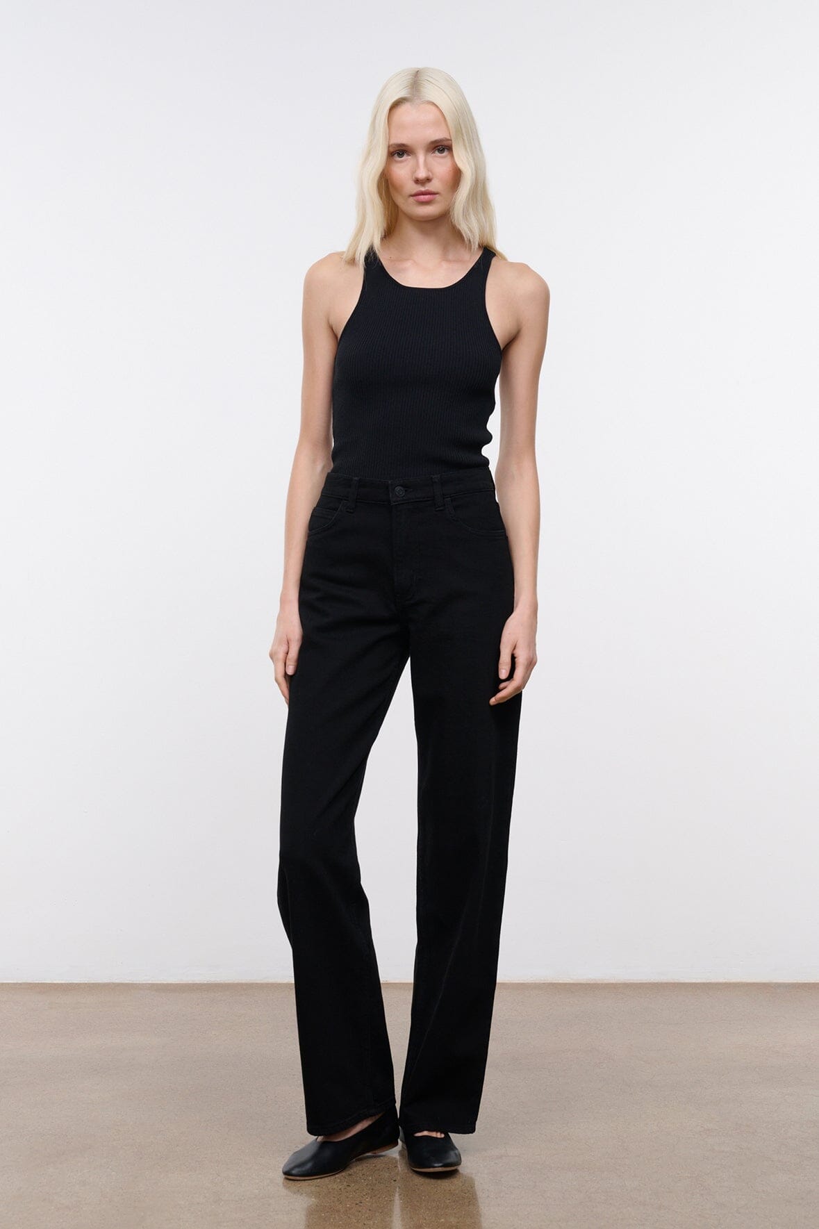 Black high-rise jeans in a wide-leg silhouette with buttoned waistband