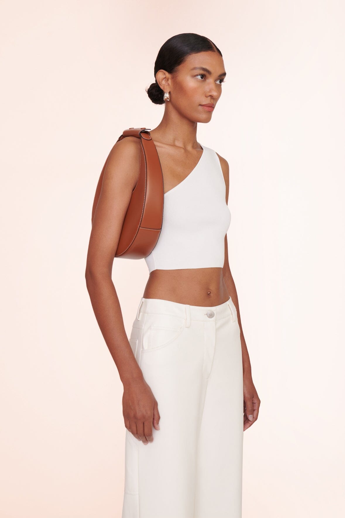 Tan crescent moon bag strap over shoulder