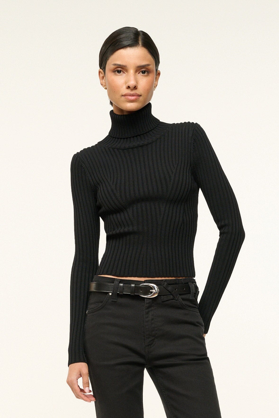 Black leather belt with silver buckle worn with black pants