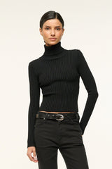 Black leather belt with silver buckle worn with black pants