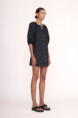 Black mini dress with V neckline, front buttons, and voluminous puff sleeves