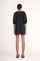 Black mini dress back view with gathered yoke and three-quarter puff sleeves