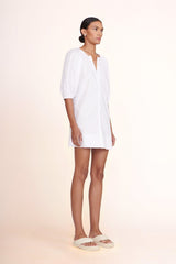 White mini dress side view with V-neck and gathered puff sleeves