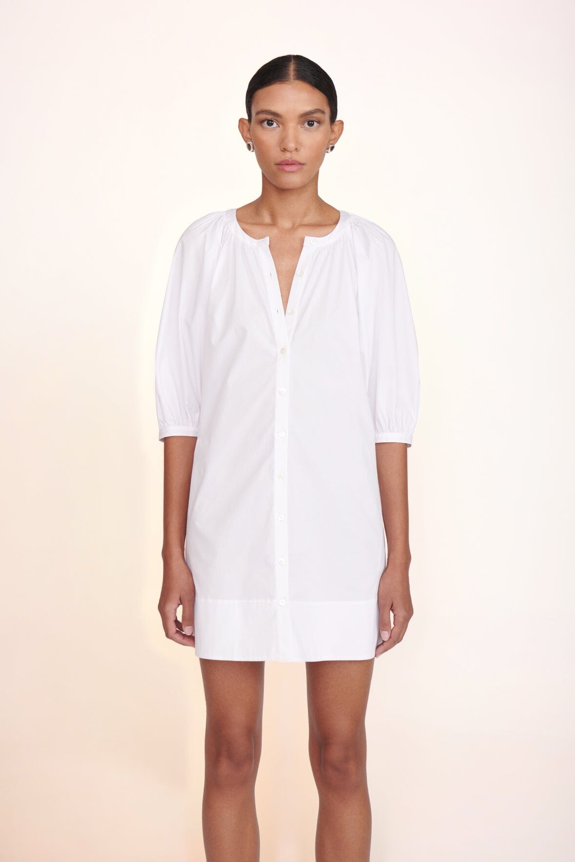 White mini dress with three-quarter puff sleeves and V-neck front buttons