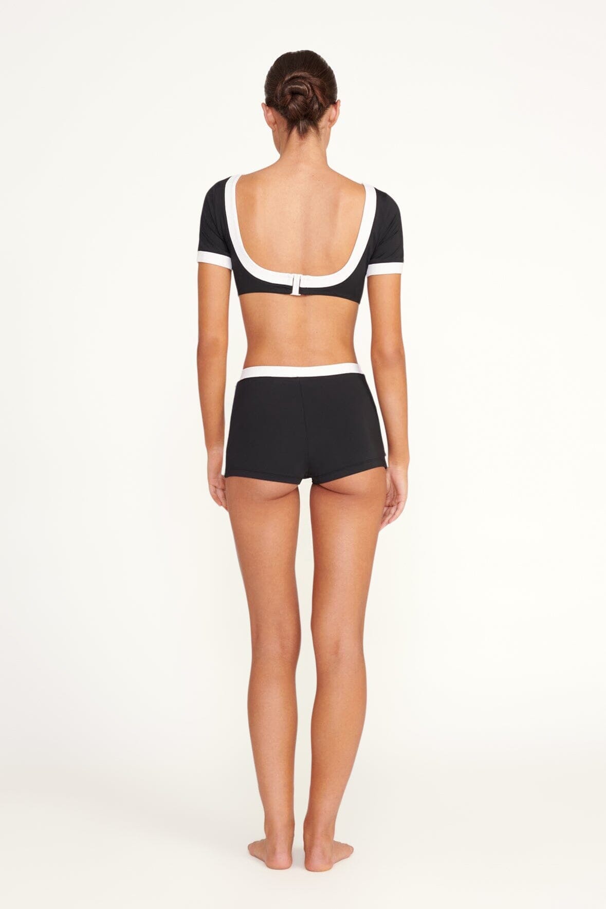 Black swim skirt with white trim, back view
