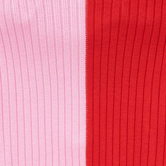 Close-up of ribbed knit fabric panels in red and pale pink stripes
