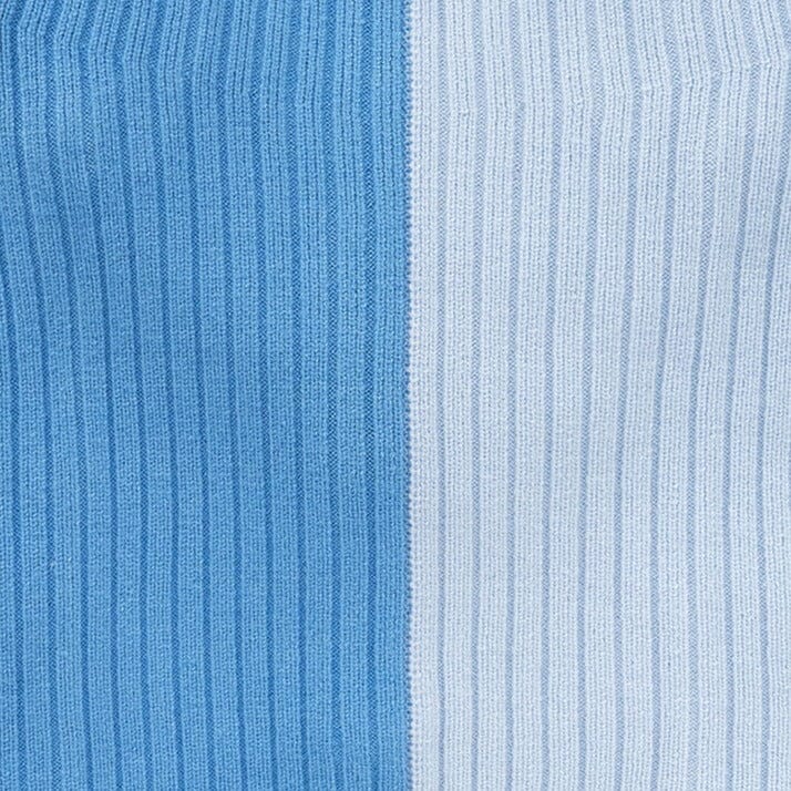 Close-up of periwinkle blue ribbed knit sweater with vertical stripe panels