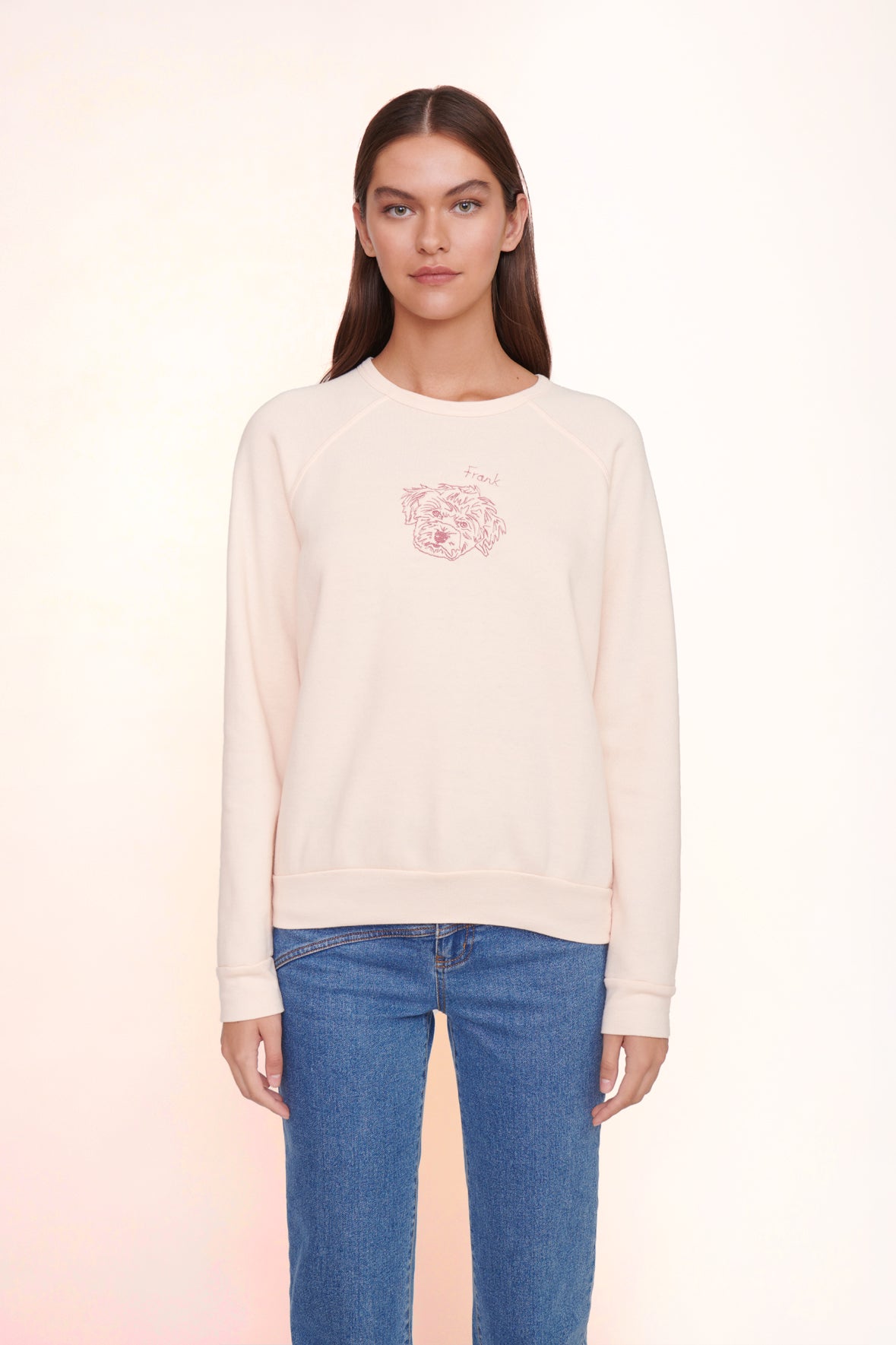 Light pink sweatshirt with small rose-like chest graphic, ribbed cuffs and hem