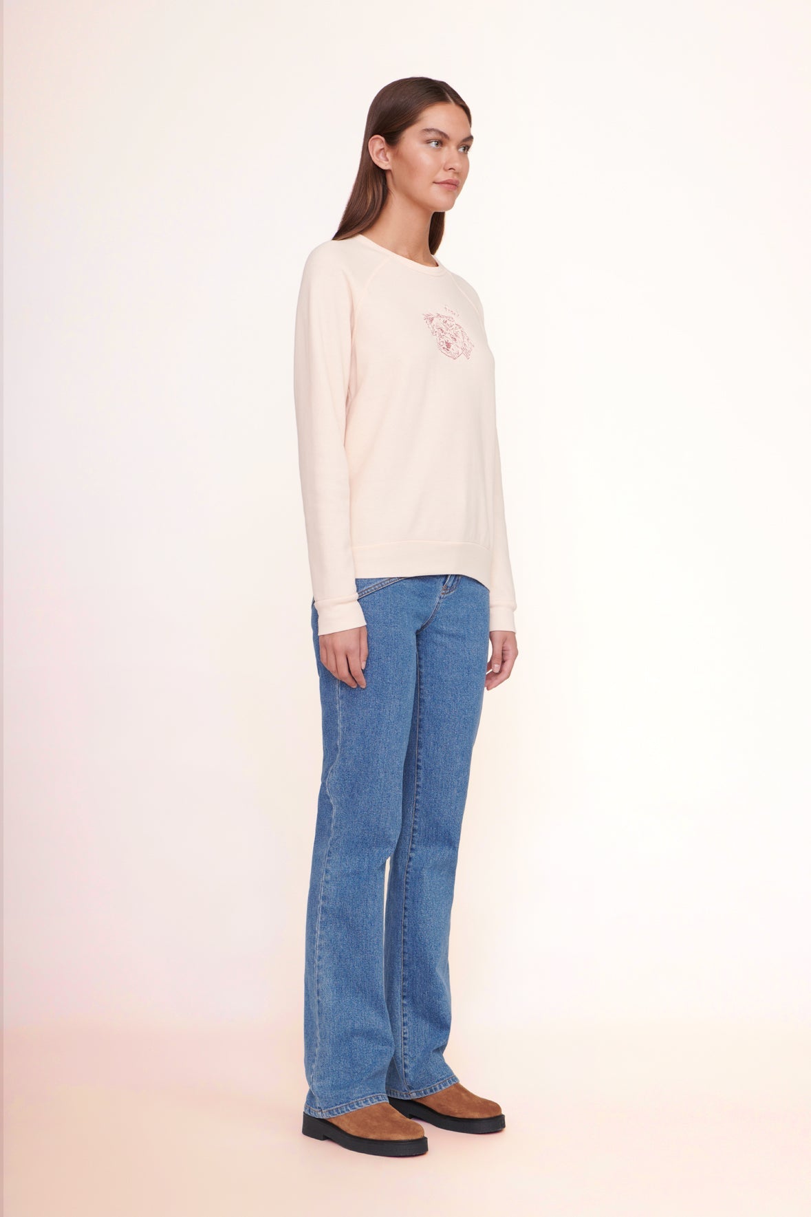 Light pink sweatshirt with small chest graphic, crew neckline and ribbed cuffs