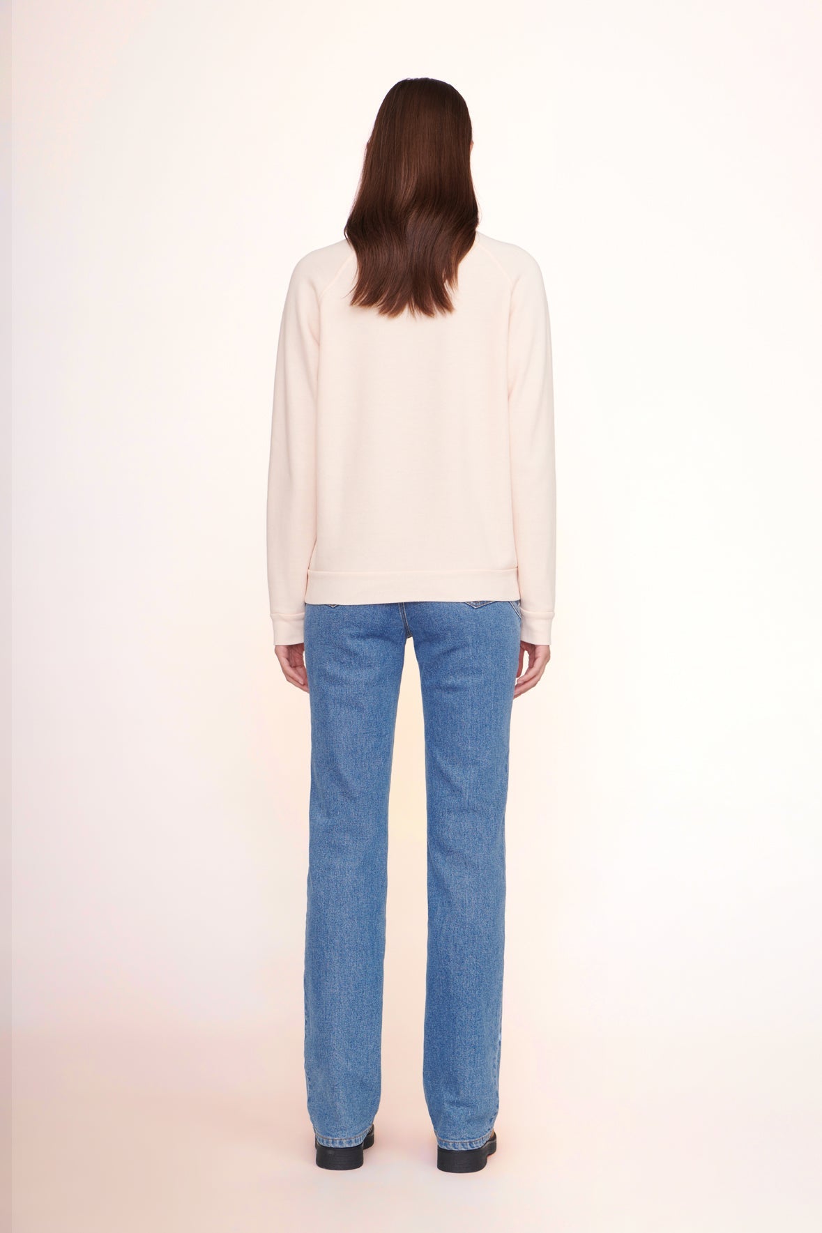Light pink sweatshirt back view with crew neckline and ribbed hem