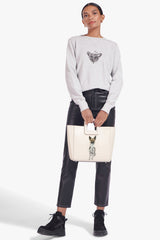 Cream leather tote bag with gold hardware and pet portrait front patch.