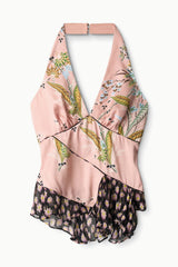 Pink silk halter top on hanger with multi-color print and ruffled hem