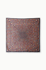 Square silk scarf with concentric geometric maze pattern in orange, blue, black