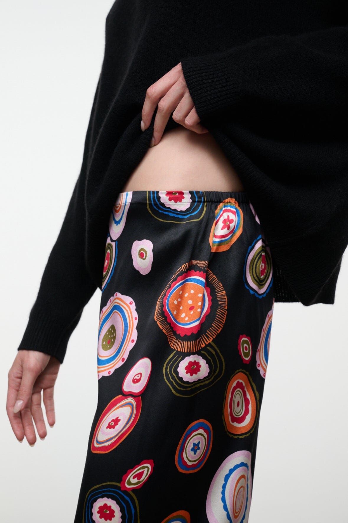 Silk pants waistband detail with black base and colorful circular paisley print