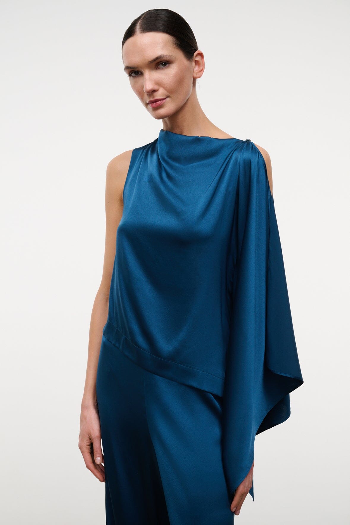 Blue sleeveless silk top with cowl neckline and draped shoulder detail