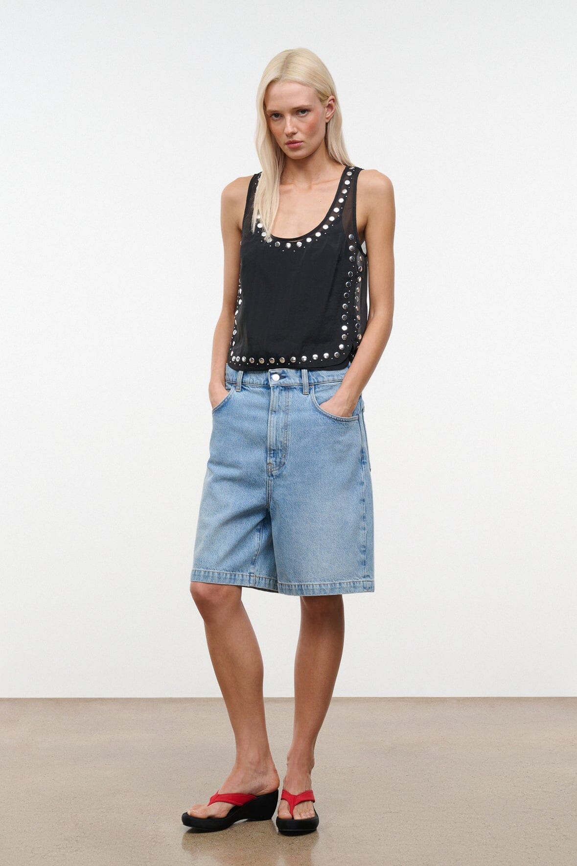 Black studded tank top with scoop neckline and silver stud trim, front view