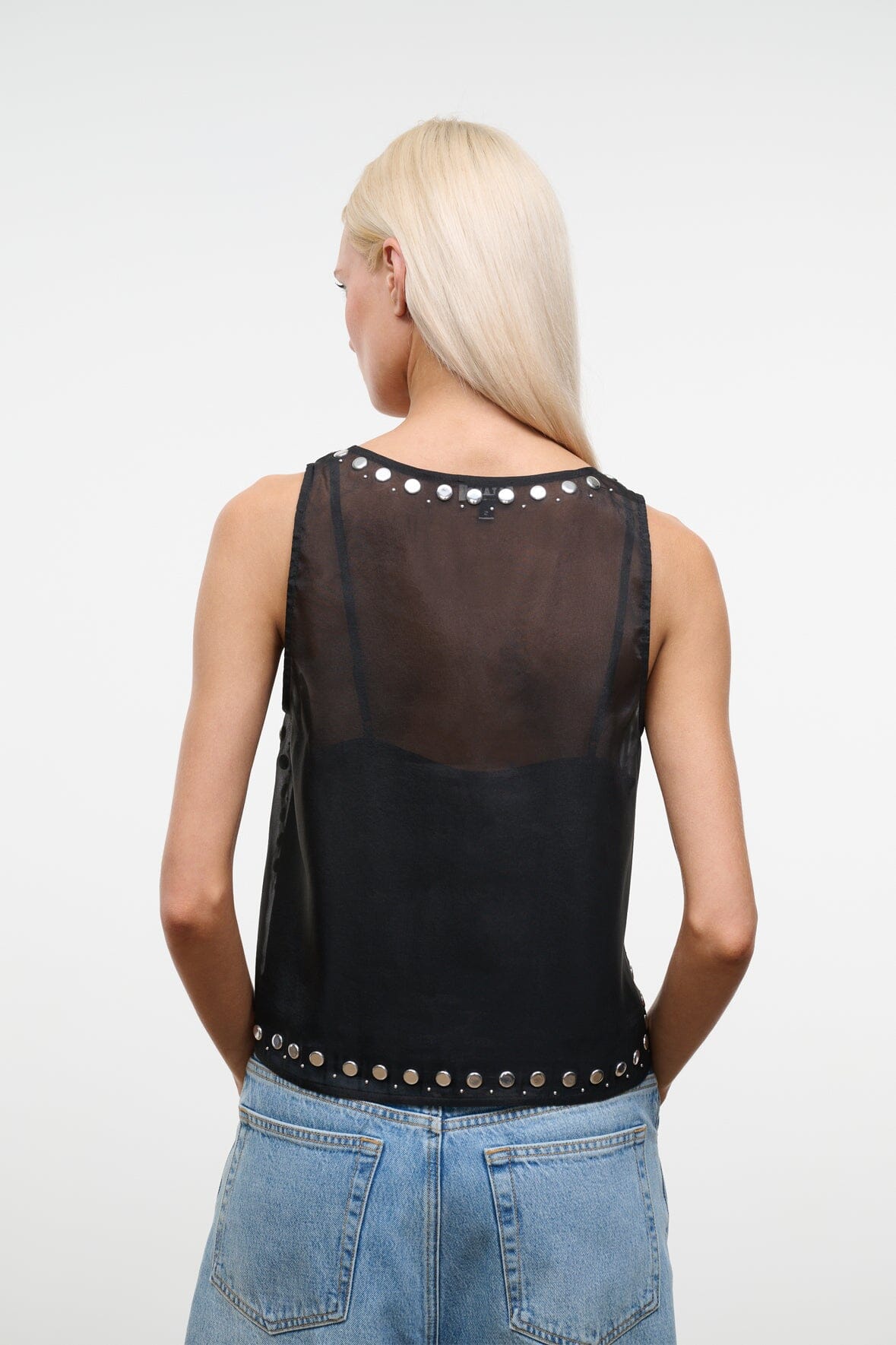 Black studded tank top with open back and silver studs along neckline and hem